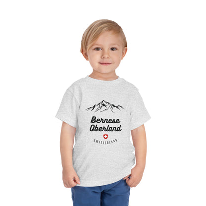 Adventurous toddler tee with mountain design and Swiss emblem