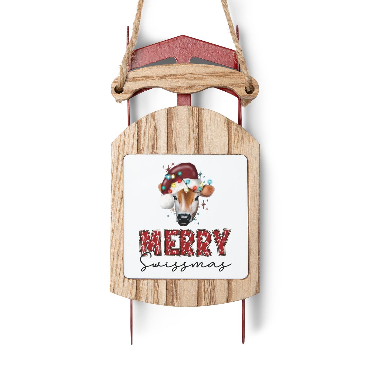 Merry Swissmas wooden sled ornament with festive cow design for Swiss Christmas decor