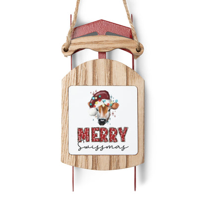 Rustic wooden sled ornament featuring Swiss cow with Santa hat and holiday lights