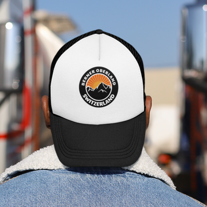 Bernese Oberland Sunset Trucker Hat featuring a retro sunset mountain outdoor badge, a perfect addition to your outdoor adventures and a stylish tribute to the Swiss Alps' majestic beauty