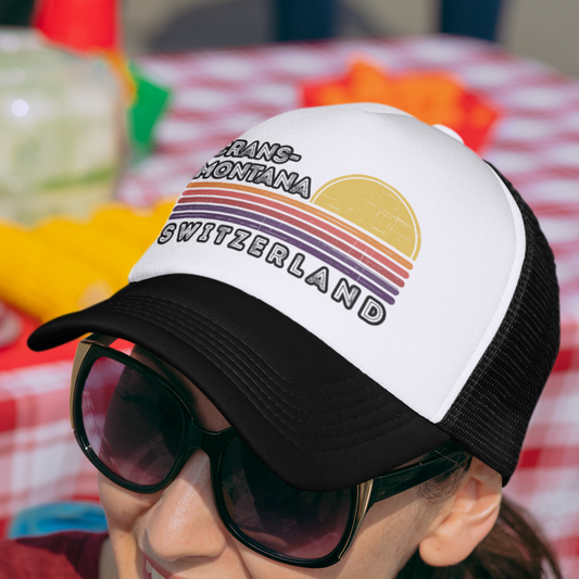 Crans-Montana Sunset Trucker Cap with a retro sunset and distressed horizontal stripes design, a perfect accessory for style-conscious outdoor enthusiasts and a fashionable tribute to the Swiss Alps' timeless beauty