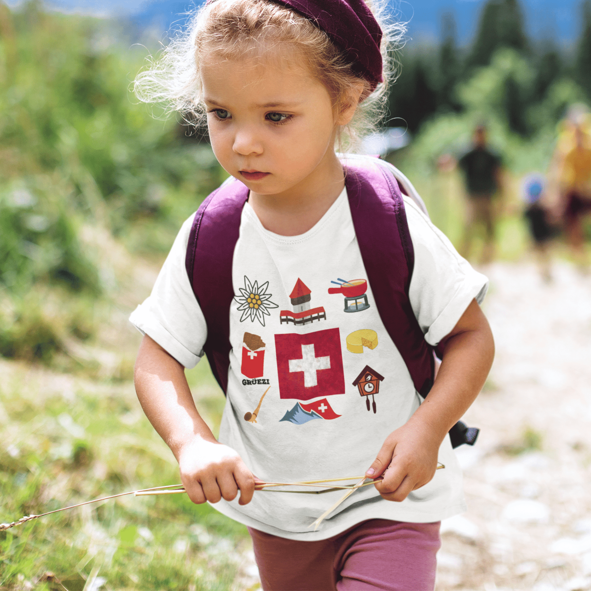 Girl wearing a Swiss travel-themed t-shirt featuring iconic elements of Switzerland's landscapes and culture. Perfect for young adventurers with a passion for exploring