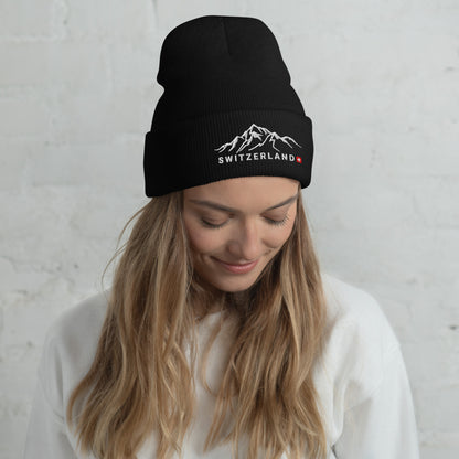 Black alpine-inspired beanie showcasing Swiss flag and mountain range design