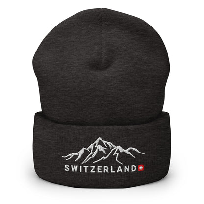 Close-up of black knit beanie featuring a detailed mountain embroidery and 'Switzerland' text