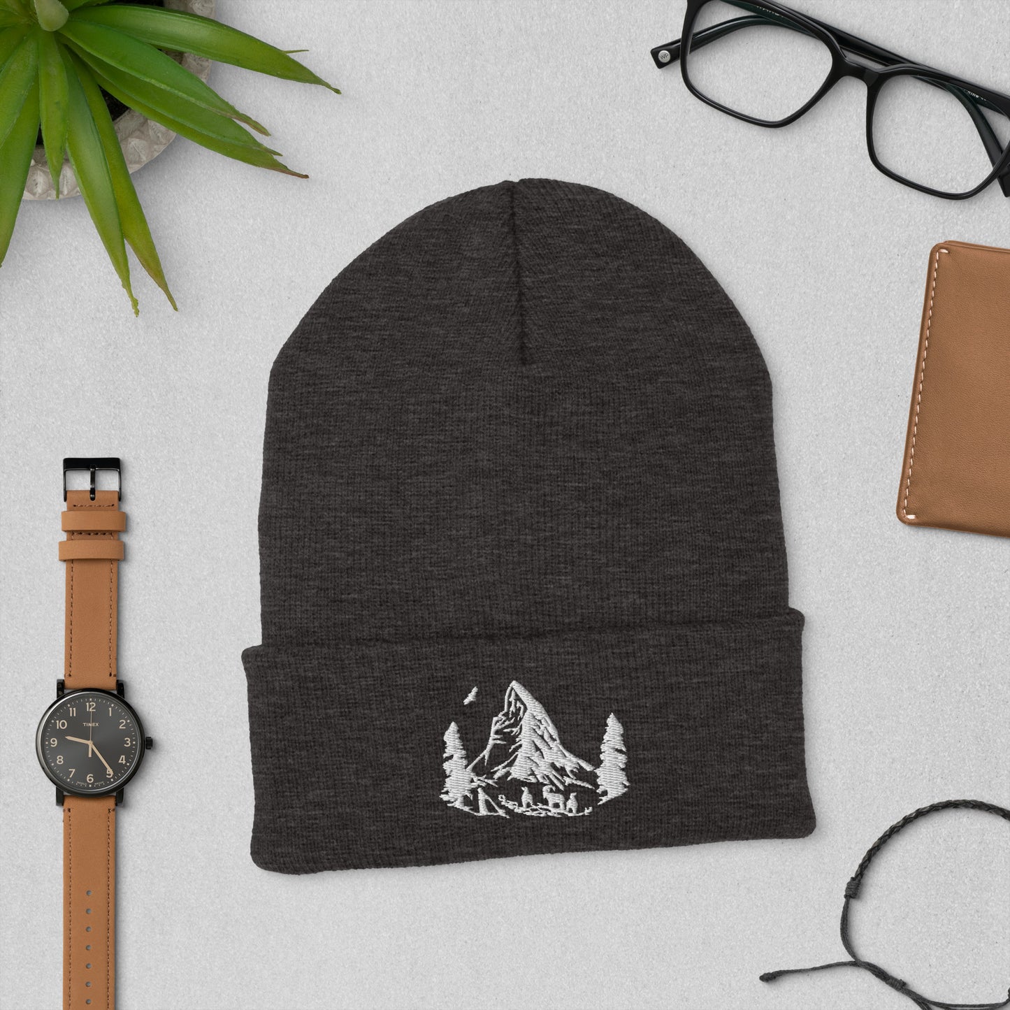 Ribbed knit beanie with embroidered Matterhorn, available in black and gray.