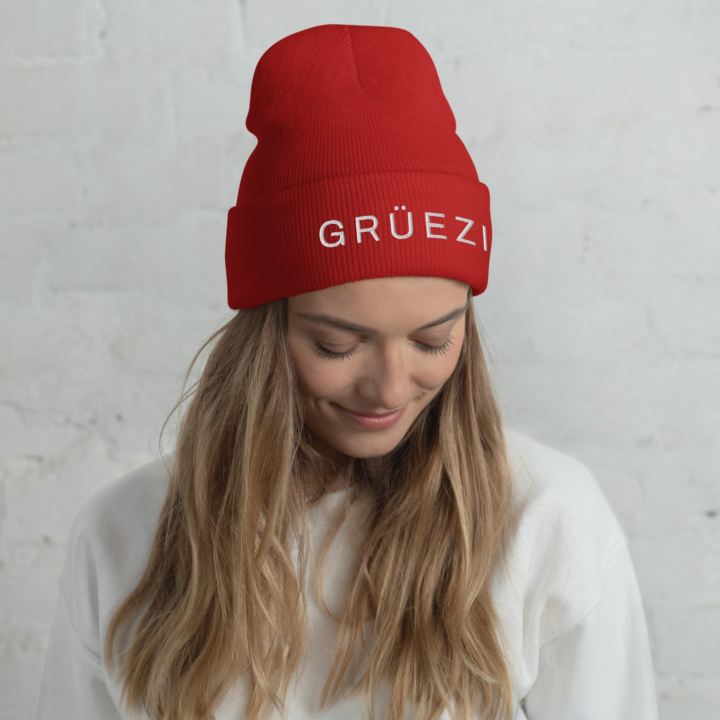 Cozy red knit beanie with embroidered Grüezi text